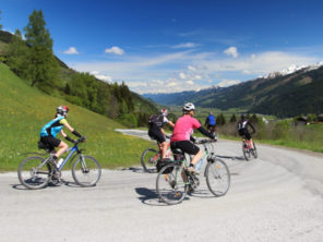 Group of cyclists descended the hill in Austrian Alps